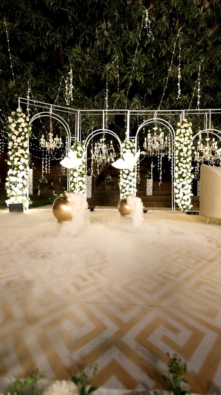 Floral arches lit by night